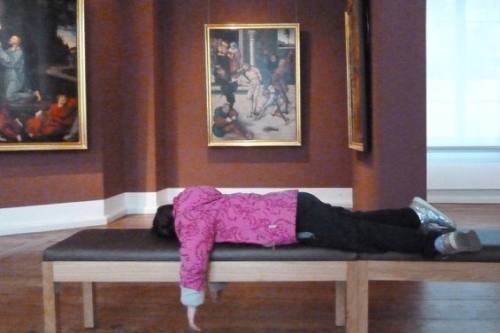 Schülerin erschöpft auf Museumsbank